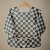 Bavoir manches longues bébé Mushie Damier Olive vert et écru