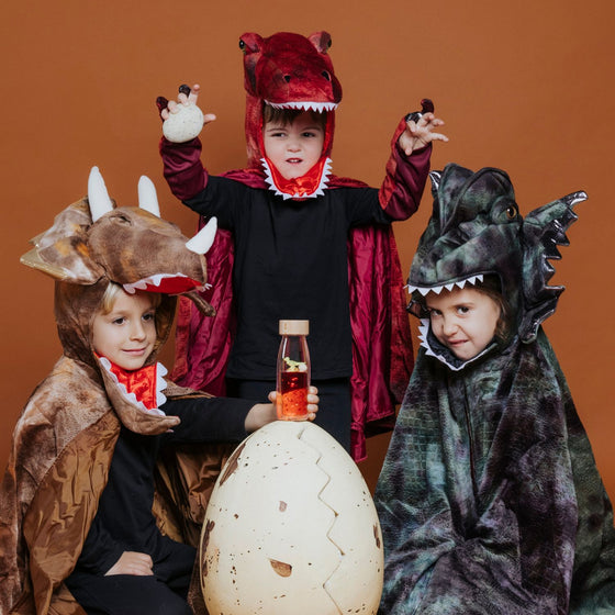 Bouteille sensorielle Petit Boum Move T-Rex avec liquide rouge et dinosaure flottant