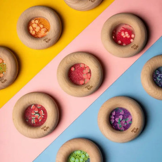 Hochet sensoriel en bois Petit Boum Donut Raisins avec perles violettes et grappes de raisin