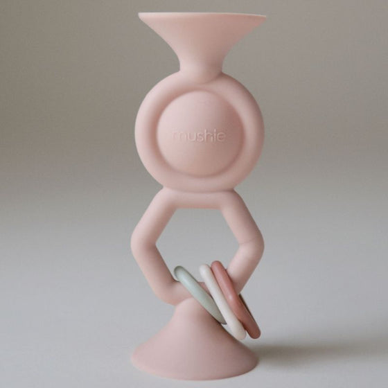 Jouet ventouse HexaPop Mushie blush en silicone avec anneaux sensoriels