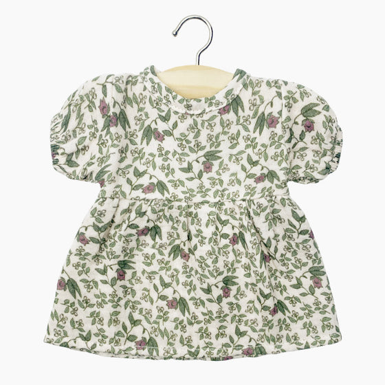 Robe "Faustine" en coton double gaze pour poupée Babies de Minikane, imprimé floral délicat sur fond écru. Modèle à manches courtes bouffantes et coupe évasée, conçu pour habiller un poupon avec élégance. Accessoire idéal pour enrichir la garde-robe des poupées.