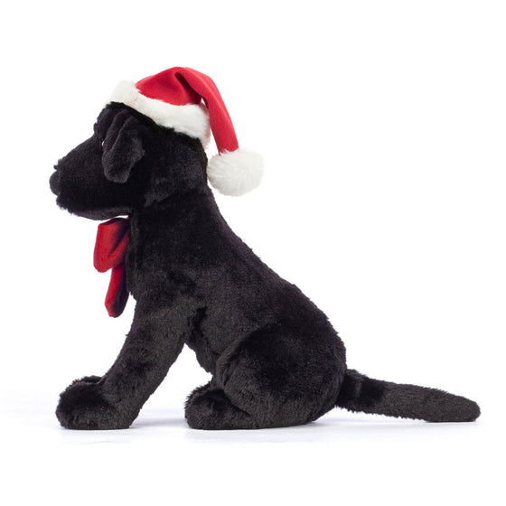 Peluche labrador noir de Noël Pippa Jellycat – chien en peluche avec bonnet et nœud rouge