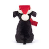 Peluche labrador noir de Noël Pippa Jellycat – chien en peluche avec bonnet et nœud rouge